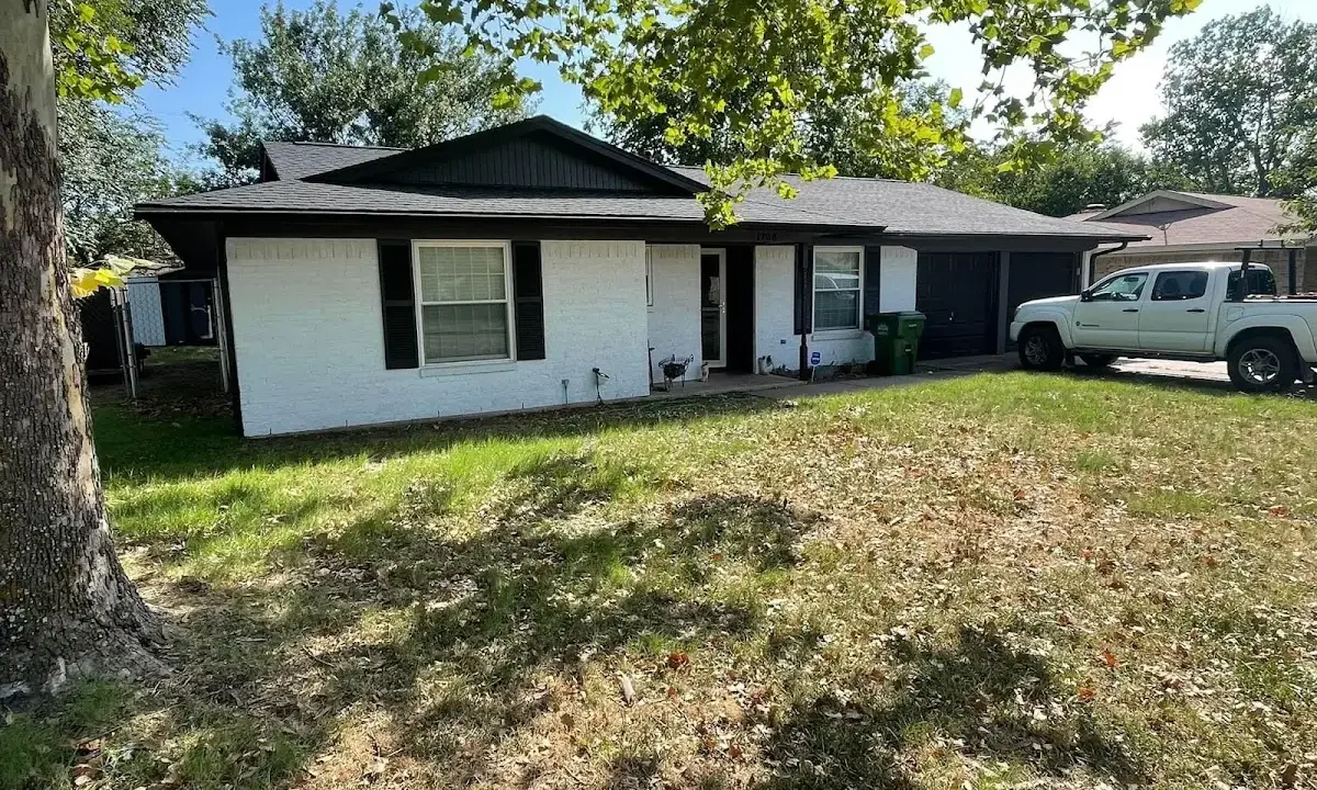 Professional roofing crew working on a residential roof in Leander